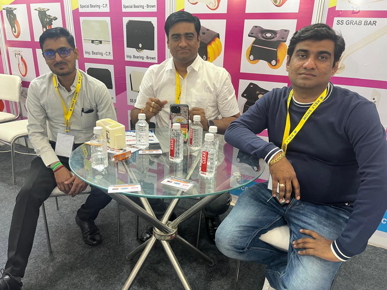 Team members seated at the Mohan Product exhibition stall